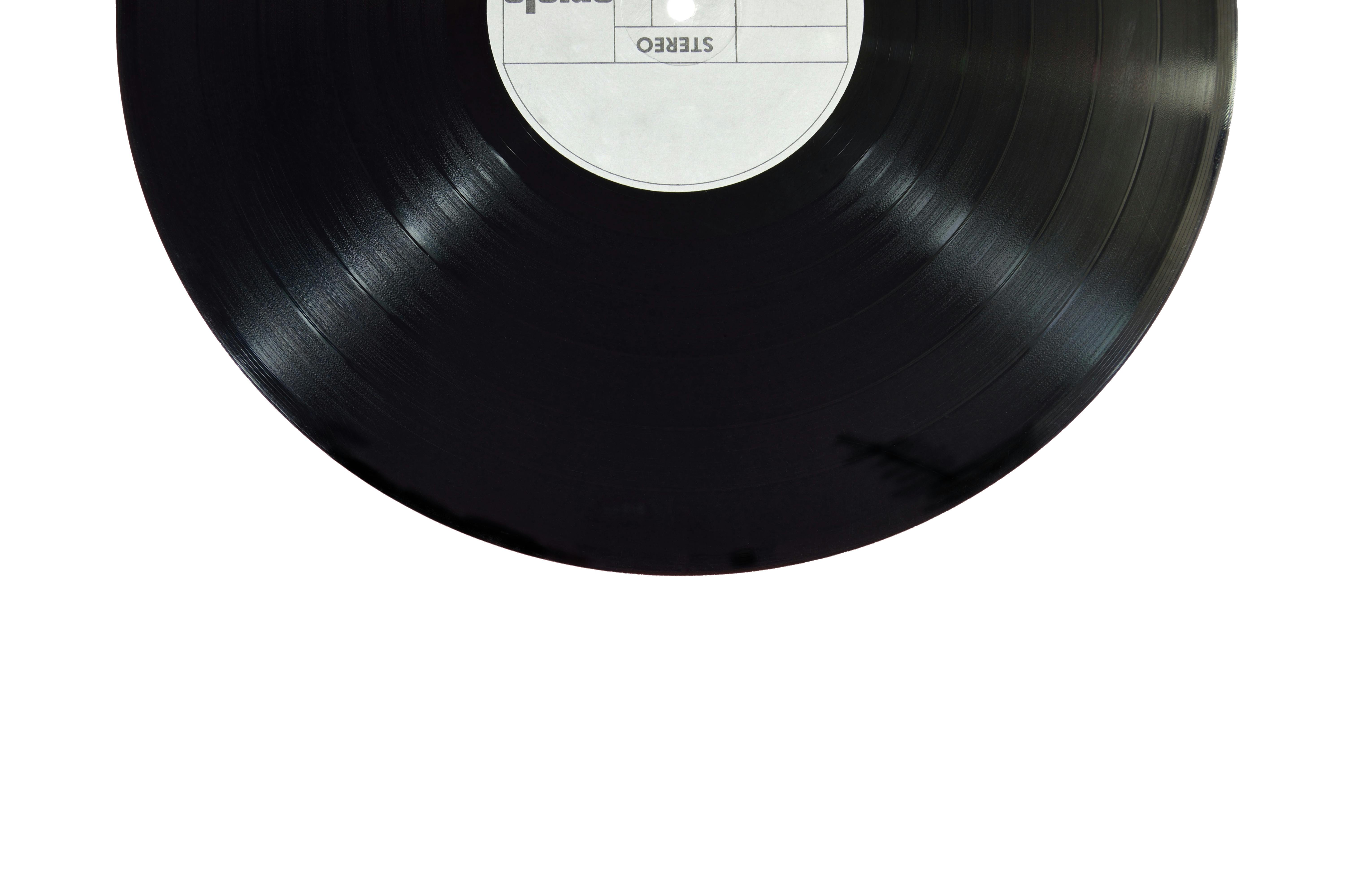 A classic black vinyl record isolated on a white background.